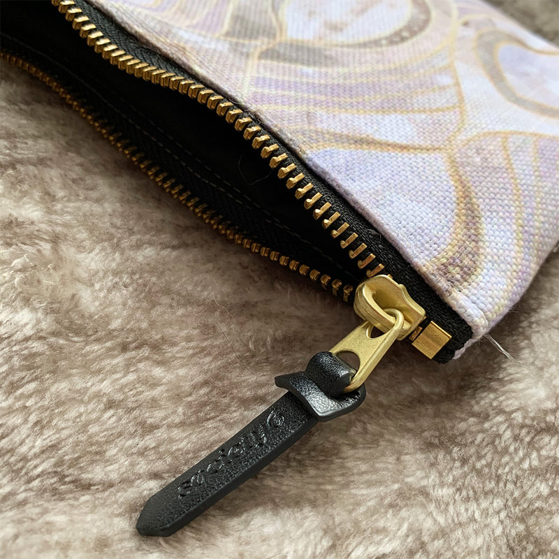 Close up shot of the Society6 carry all pouch unzipped with faux leather zipper tag
